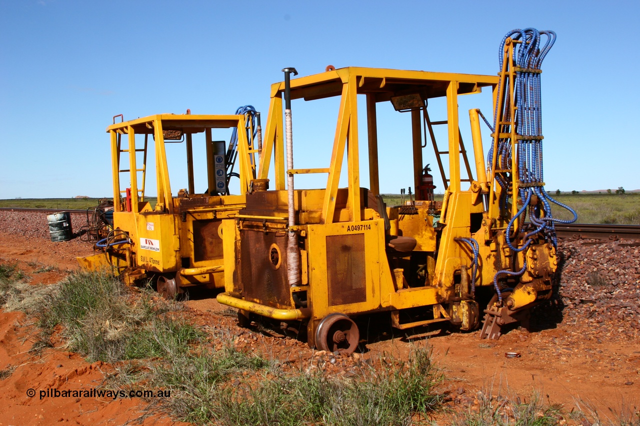 050625 3814
Node 2 at the 38 km on the GML or former Goldsworthy mainline, two Barclay Mowlem sleeper inserter track machines off clear of the running lines. 25th June 2005.
Keywords: track-machine;