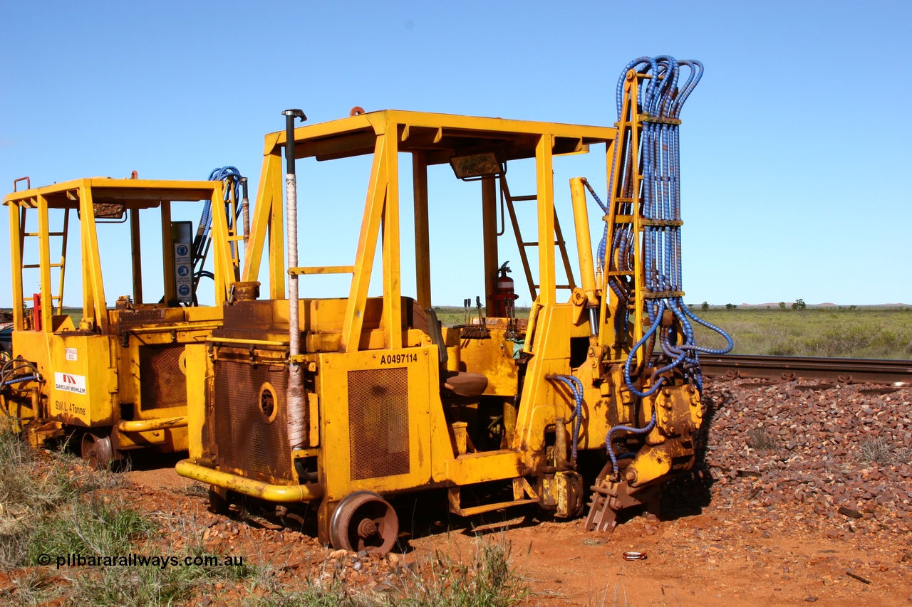 050625 3815
Node 2 at the 38 km on the GML or former Goldsworthy mainline, two Barclay Mowlem sleeper inserter track machines off clear of the running lines. 25th June 2005.
Keywords: track-machine;