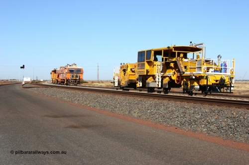 060710 6235
At the Broome Rd grade crossing Port Hedland, track machine BR 33 a Plasser Australia ballast regulator model SSP 302 serial M486 follows Plasser Australia Unimat S4 switch tamper SW 02 as the head south. 10th July 2006.
Keywords: track-machine;