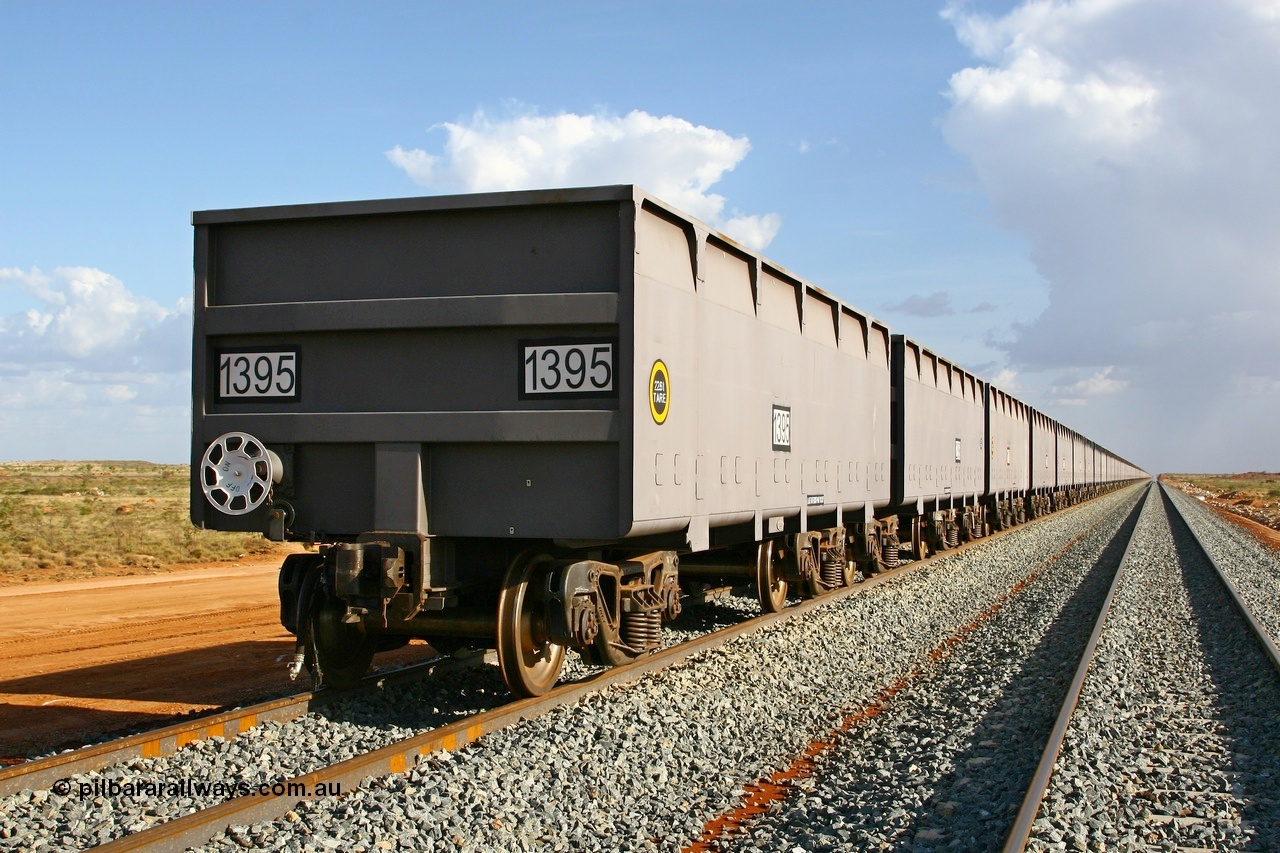 080116 1367
Chapman Siding at the 69 km on FMG's under construction line to Cloud Break mine, new waggons stabled in the passing track awaiting service, built by China Southern or CSR at their Zhuzhou Rolling Stock Works in China in 2007, looking south along the rake with 1395 closest to the camera. 16th January 2008.
Keywords: 1395;CSR-Zhuzhou-Rolling-Stock-Works-China;FMG-ore-waggon;