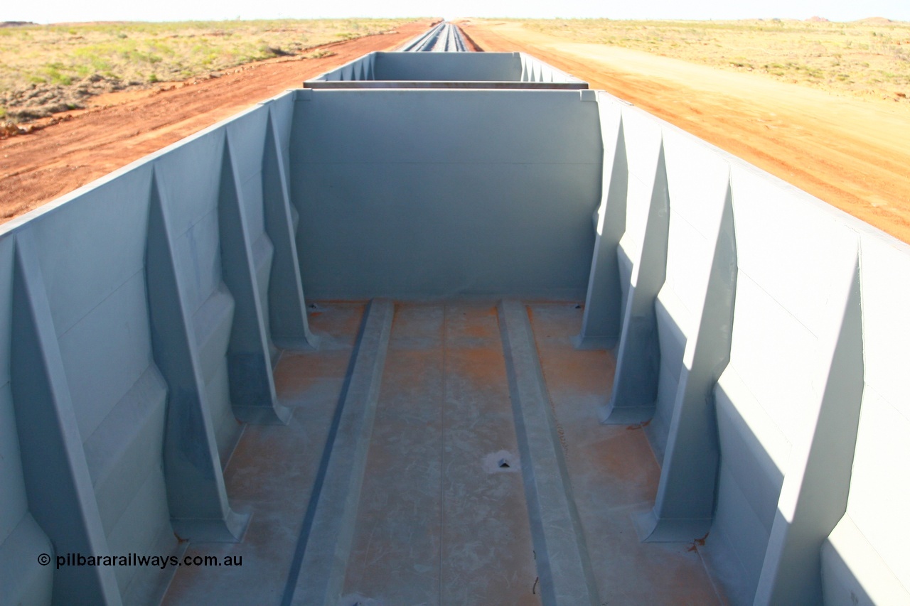 080116 1381
Chapman Siding looking north inside ore waggon 2396. The visible angle iron welded to the floor are covers for the water drain holes.
Keywords: 2396;CSR-Zhuzhou-Rolling-Stock-Works-China;FMG-ore-waggon;