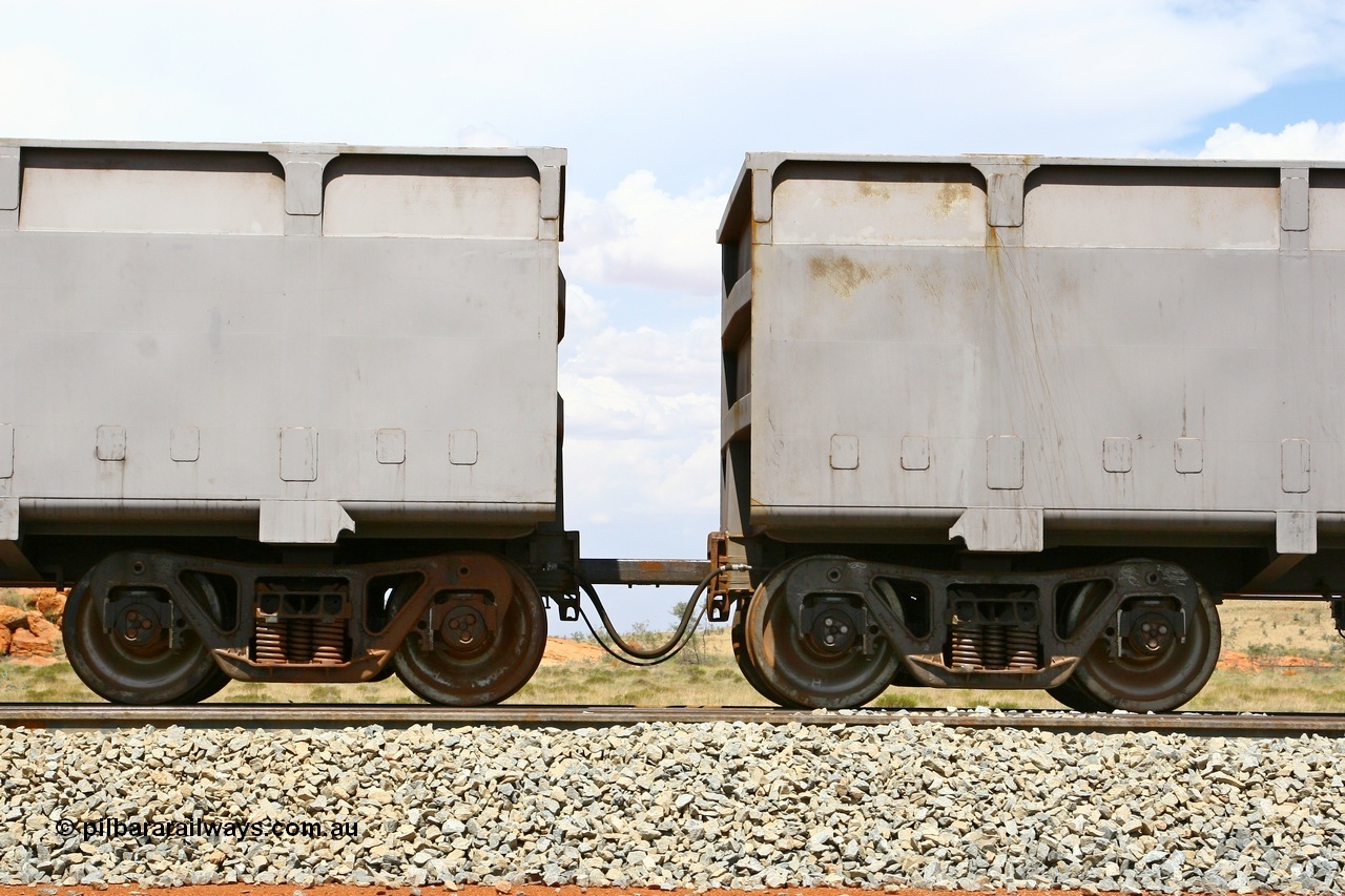 080124 1633
Chapman Siding, detail of the bar coupling arrangement showing bar, the large hose is the through brake pipe and the small hose the control pipe for the slave waggon. 24th January 2008.
Keywords: FMG-ore-waggon;