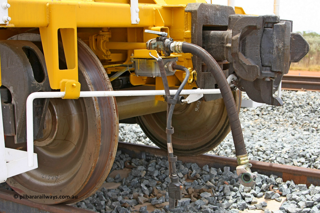 081225 0568
Barker Siding, one of FMG's thirty five ballast waggons, BH 11, view of F type coupler and air and electric connections, 100 tonne capacity, built in China by CSR at the Yangtze Rolling Stock Company in 2008. December 25, 2008.
Keywords: BH11;CSR-Yangtze-Rolling-Stock-Co-China;FMG-ballast-waggon;