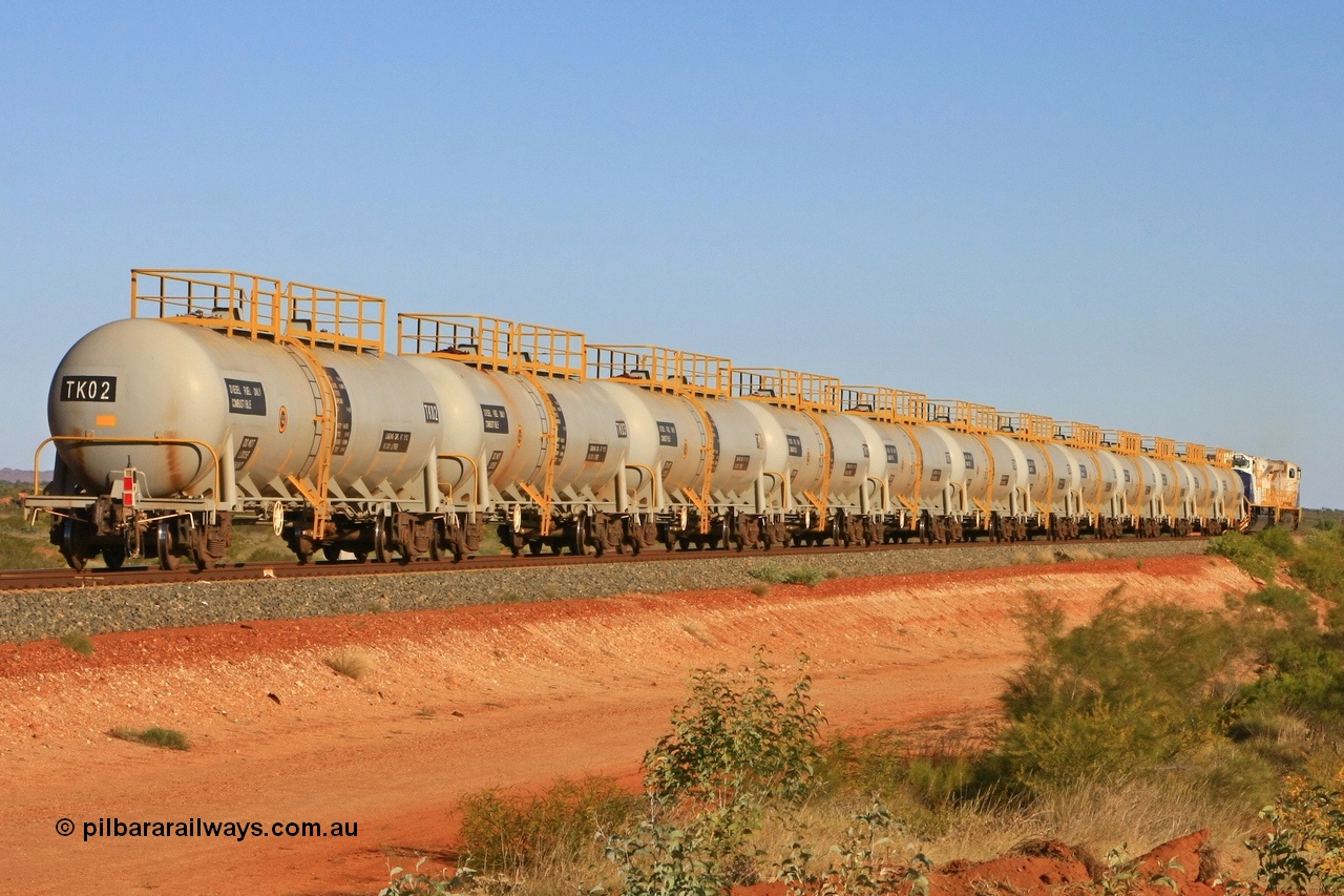 110620 2284
Chapman, the entire fleet of twelve FMG TK type fuel tank waggons all built in 2008 by CSR Zhuzhou Rolling Stock Works plant in China hurry south on the loaded run of the fuel train to Cloud Break mine. 20th June 2011.
Keywords: TK02;TK-type;CSR-Zhuzhou-Rolling-Stock-Works-China;FMG-tank-waggon;