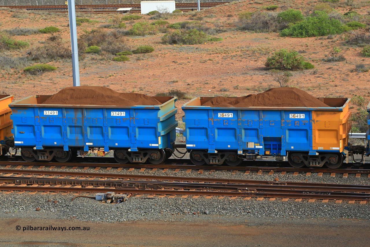 240619 0376
Cape Lambert yard, one of Rio Tinto's blue rakes with spring park brake and only electronic controlled pneumatic [ECP] braking, waggon pair 31491 is a master and is bar coupled to slave waggon 36491 built by China Northen as a Q type in 12/2022. Captured on June 19, 2024.
Keywords: 31491;36491;Q-type;China-Northern;Rio-ore-waggon;