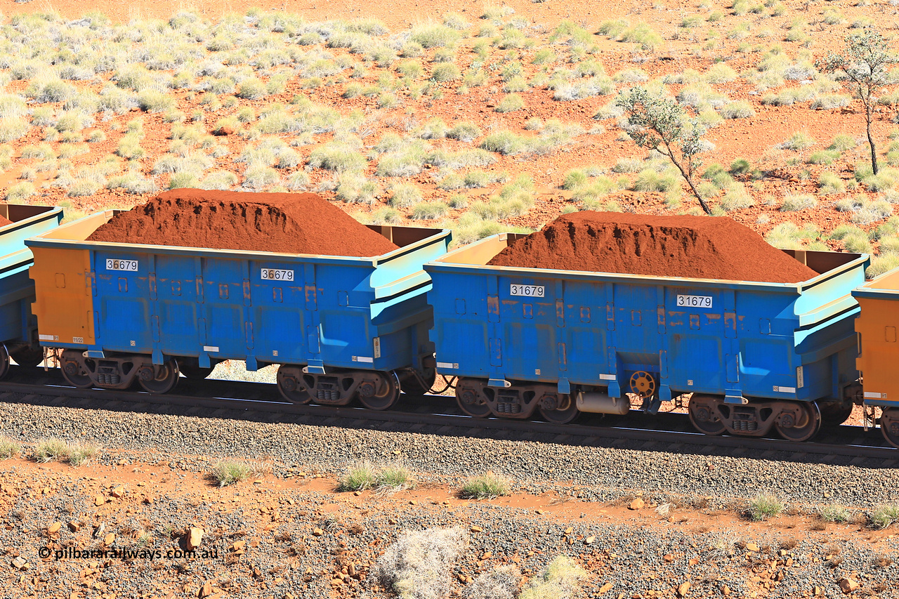 240701 2393
Western Creek, 67 km, one of Rio Tinto's blue rakes with spring assisted park brake and only electronic controlled pneumatic [ECP] braking, waggon pair 31679 is a master and is bar coupled to slave waggon 36679 built by China Northen as a Q type in 11/2022. Captured on July 1, 2024.
Keywords: 31679;36679;Q-type;China-Northern;Rio-ore-waggon;