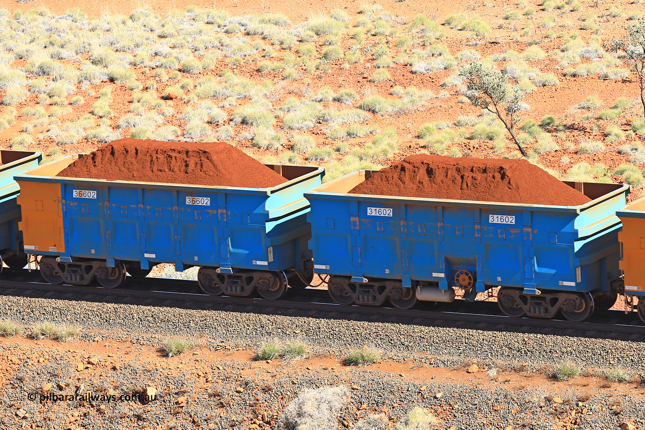 240701 2412
Western Creek, 67 km, one of Rio Tinto's blue rakes with spring assisted park brake and only electronic controlled pneumatic [ECP] braking, waggon pair 31602 is a master and is bar coupled to slave waggon 36602 built by China Northen as a Q type in 11/2022. Captured on July 1, 2024.
Keywords: 31602;36602;Q-type;China-Northern;Rio-ore-waggon;