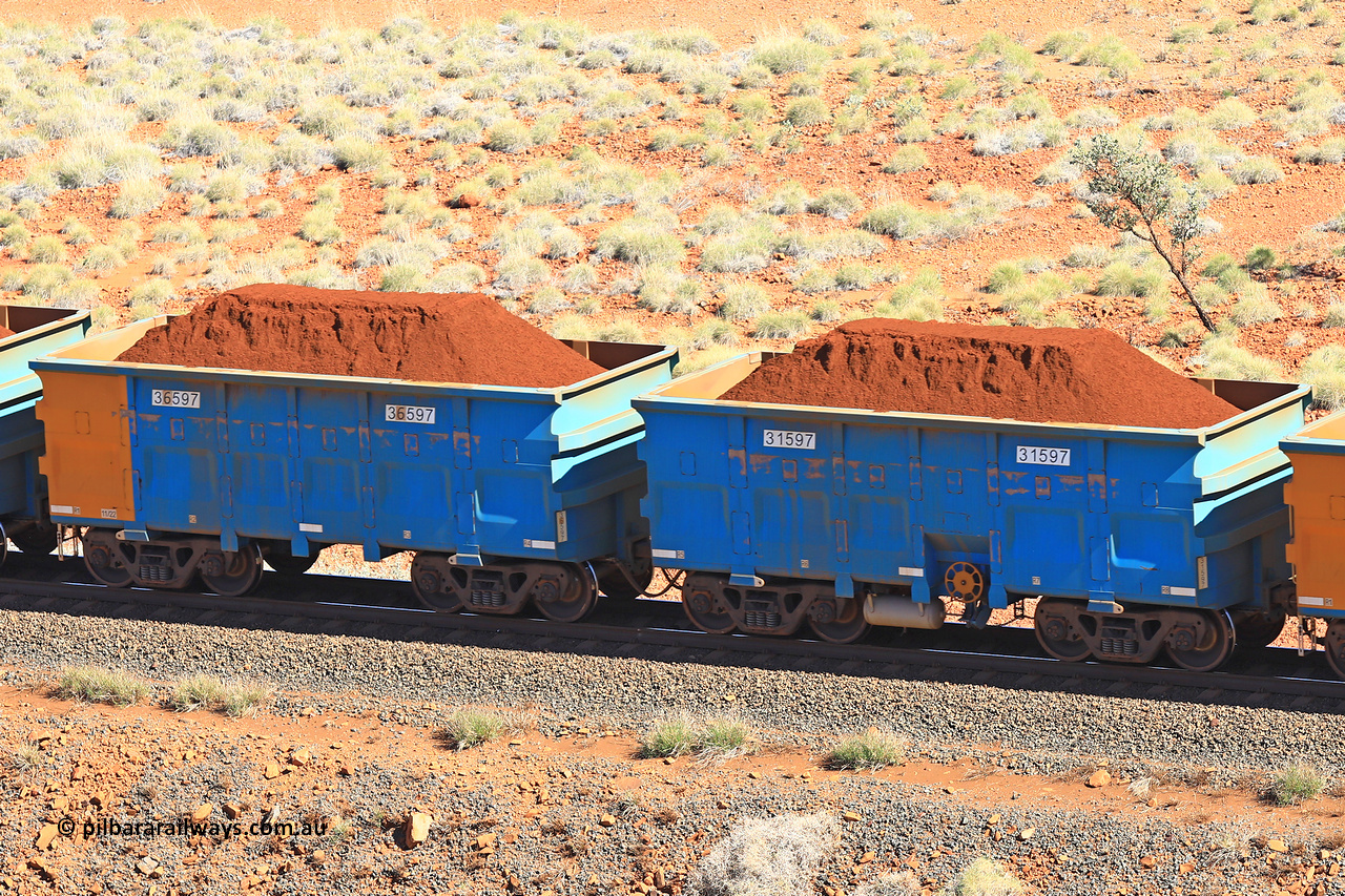 240701 2423
Western Creek, 67 km, one of Rio Tinto's blue rakes with spring assisted park brake and only electronic controlled pneumatic [ECP] braking, waggon pair 31597 is a master and is bar coupled to slave waggon 36597 built by China Northen as a Q type in 11/2022. Captured on July 1, 2024.
Keywords: 31597;36597;Q-type;China-Northern;Rio-ore-waggon;