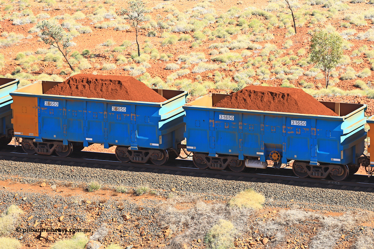 240701 2469
Western Creek, 67 km, one of Rio Tinto's blue rakes with spring assisted park brake and only electronic controlled pneumatic [ECP] braking, waggon pair 31650 is a master and is bar coupled to slave waggon 36650 built by China Northen as a Q type in 12/2022. Captured on July 1, 2024.
Keywords: 31650;36650;Q-type;China-Northern;Rio-ore-waggon;
