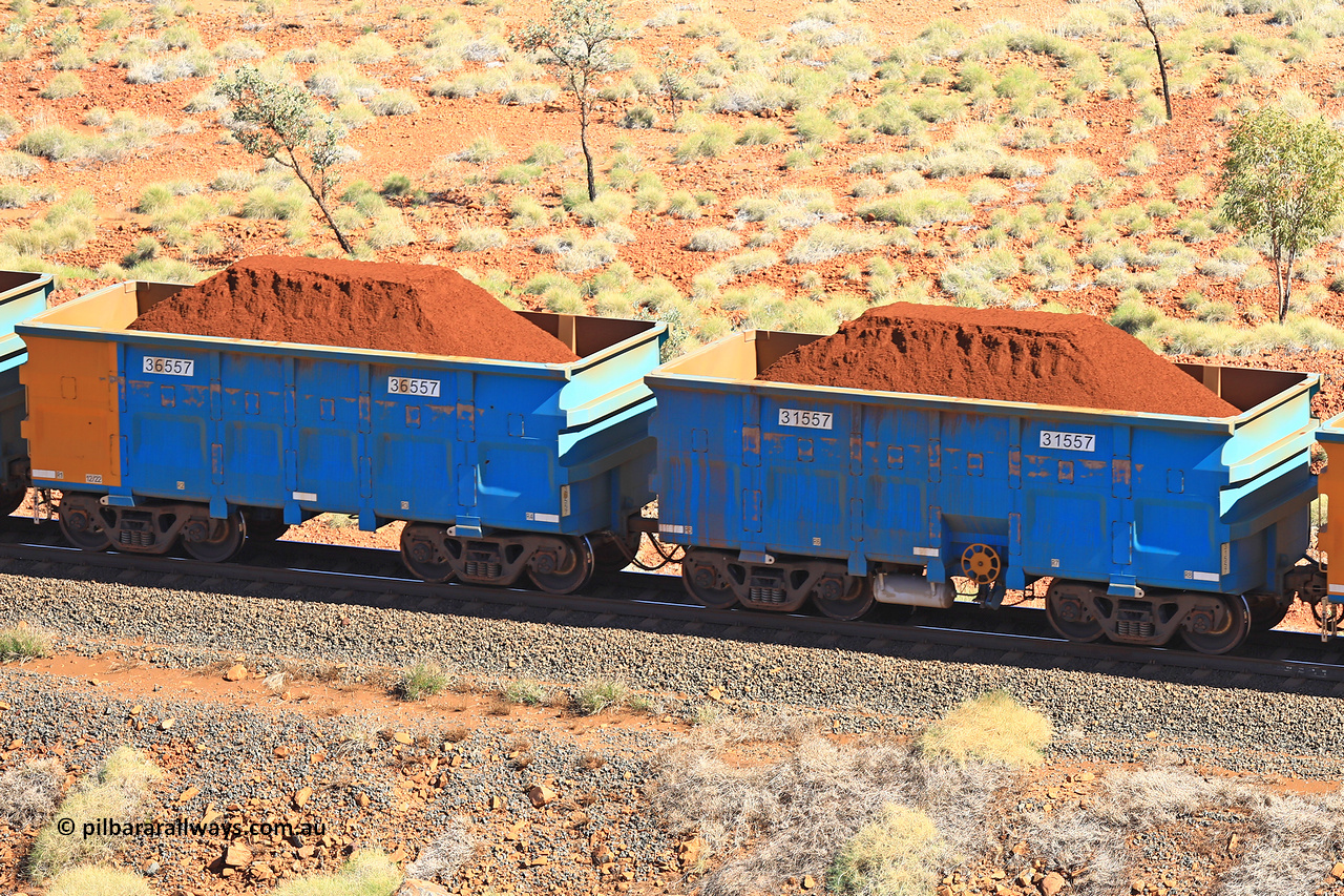 240701 2476
Western Creek, 67 km, one of Rio Tinto's blue rakes with spring assisted park brake and only electronic controlled pneumatic [ECP] braking, waggon pair 31557 is a master and is bar coupled to slave waggon 36557 built by China Northen as a Q type in 12/2022. Captured on July 1, 2024.
Keywords: 31557;36557;Q-type;China-Northern;Rio-ore-waggon;