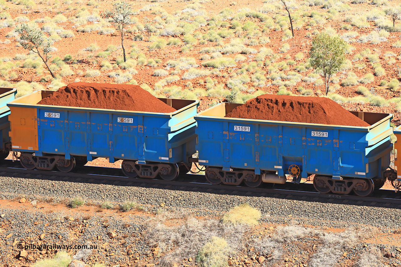 240701 2497
Western Creek, 67 km, one of Rio Tinto's blue rakes with spring assisted park brake and only electronic controlled pneumatic [ECP] braking, waggon pair 31591 is a master and is bar coupled to slave waggon 36591 built by China Northen as a Q type in 11/2022. Captured on July 1, 2024.
Keywords: 31591;36591;Q-type;China-Northern;Rio-ore-waggon;