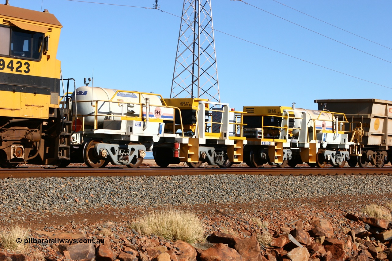 060723 7684
Original Hamersley Iron compressor waggon sets IC-6 and IC-7 which were made from cutting down condemned ore waggons and then fitting Atlas Copco XAS 97 air compressors, receiver tanks and fuel tanks. Seen here on the causeway just outside 7 Mile. 23rd July 2006.
Keywords: IC-6;IC-7;rio-compressor-waggon;