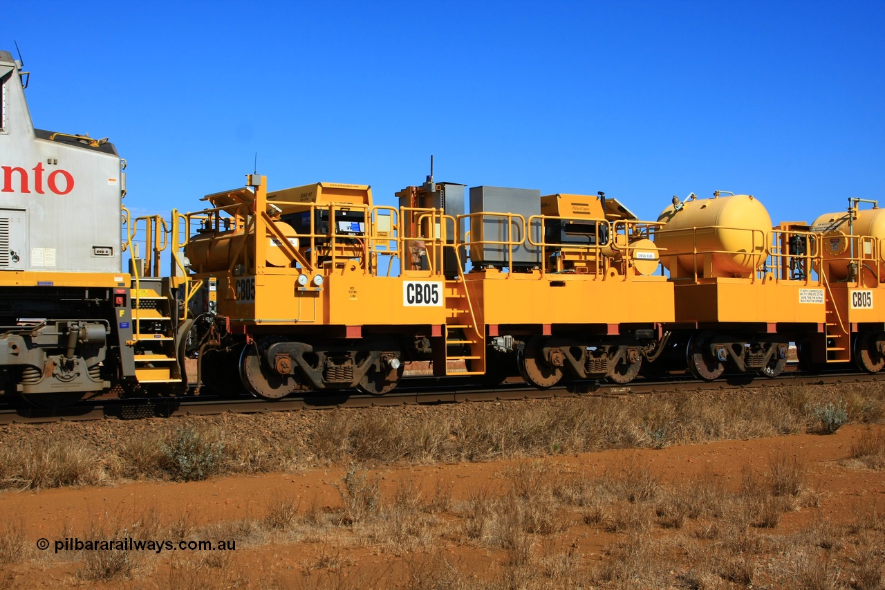 100330 8066
Rio Tinto compressor waggon set CB 05, compressor control waggon with two diesel powered Atlas Copco XAS 97's behind the loco and the receiver waggon with two air tanks or receivers closet to camera. Note the waggons are cut down ore waggons. Seen here just outside of 7 Mile. 30th March 2010.
Keywords: CB05;rio-compressor-waggon;