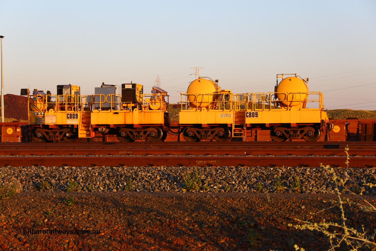 170510 8294
Rio Tinto compressor waggon set CB 09, compressor control waggon with two diesel powered Kaeser M57 Utility air compressors and the receiver waggon with two air tanks or receivers. Note the waggons are modified ore waggon frames. Seen here at Cape Lambert. 10th May 2017.
Keywords: CB09;rio-compressor-waggon;