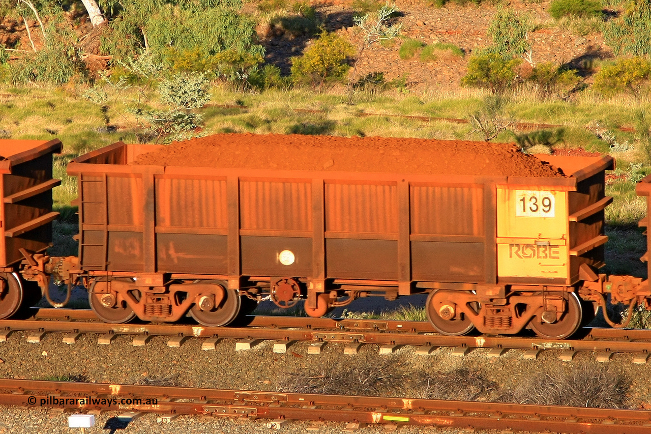 0139 110602 1666
Robe River ore waggon 139, built by Nippon Sharyo Nihon, rotary coupler end handbrake side loaded view at the 71 km, Western Creek on the Deepdale line. June 2, 2011.
Keywords: 139;Nippon-Sharyo-Nihon;Robe-ore-waggon;