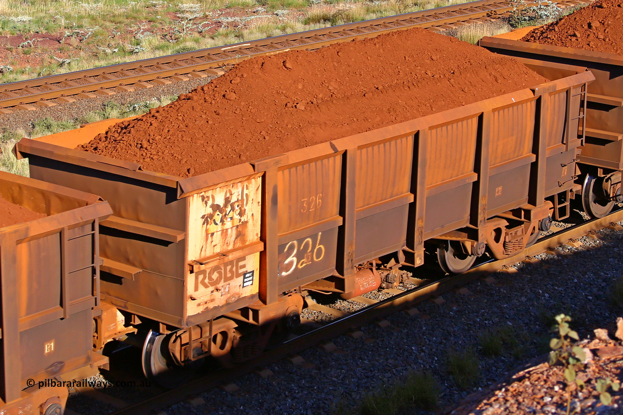 0326 210322 9690
Robe River ore waggon 326, built by Nippon Sharyo Nihon, rotary coupler end non-handbrake side loaded view at the 17 km on the Cape Lambert line, March 22, 2021.
Keywords: 326;Nippon-Sharyo-Nihon;Robe-ore-waggon;