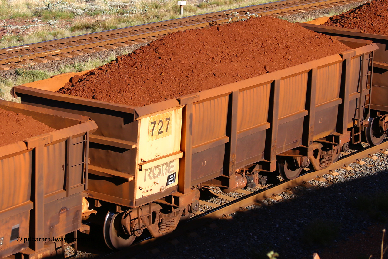 0727 210322 9733
Robe River ore waggon 727, built by Tomlinson Steel WA, rotary coupler end non-handbrake side loaded view at the 17 km on the Cape Lambert line, March 22, 2021.
Keywords: 727;Tomlinson-Steel-WA;Robe-ore-waggon;