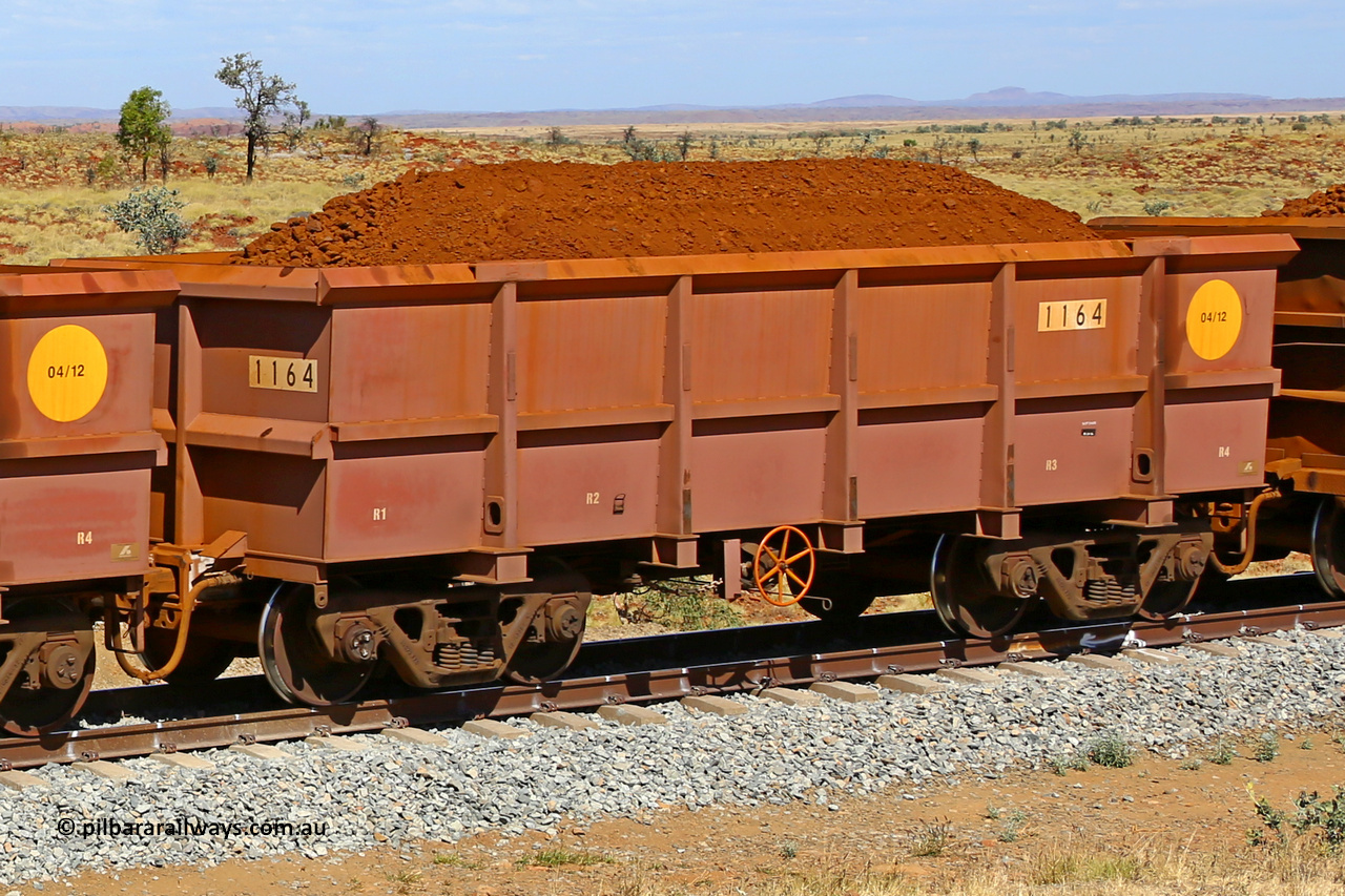 1164 170729 0263
Robe River ore waggon 1164, built by Bradken Rail Qld in April 2012, fixed coupler handbrake side loaded view at the 103 km, between Maitland Siding and the Fortescue River on the Deepdale line. July 29, 2017.
Keywords: 1164;Bradken-Rail-Qld;Robe-ore-waggon;