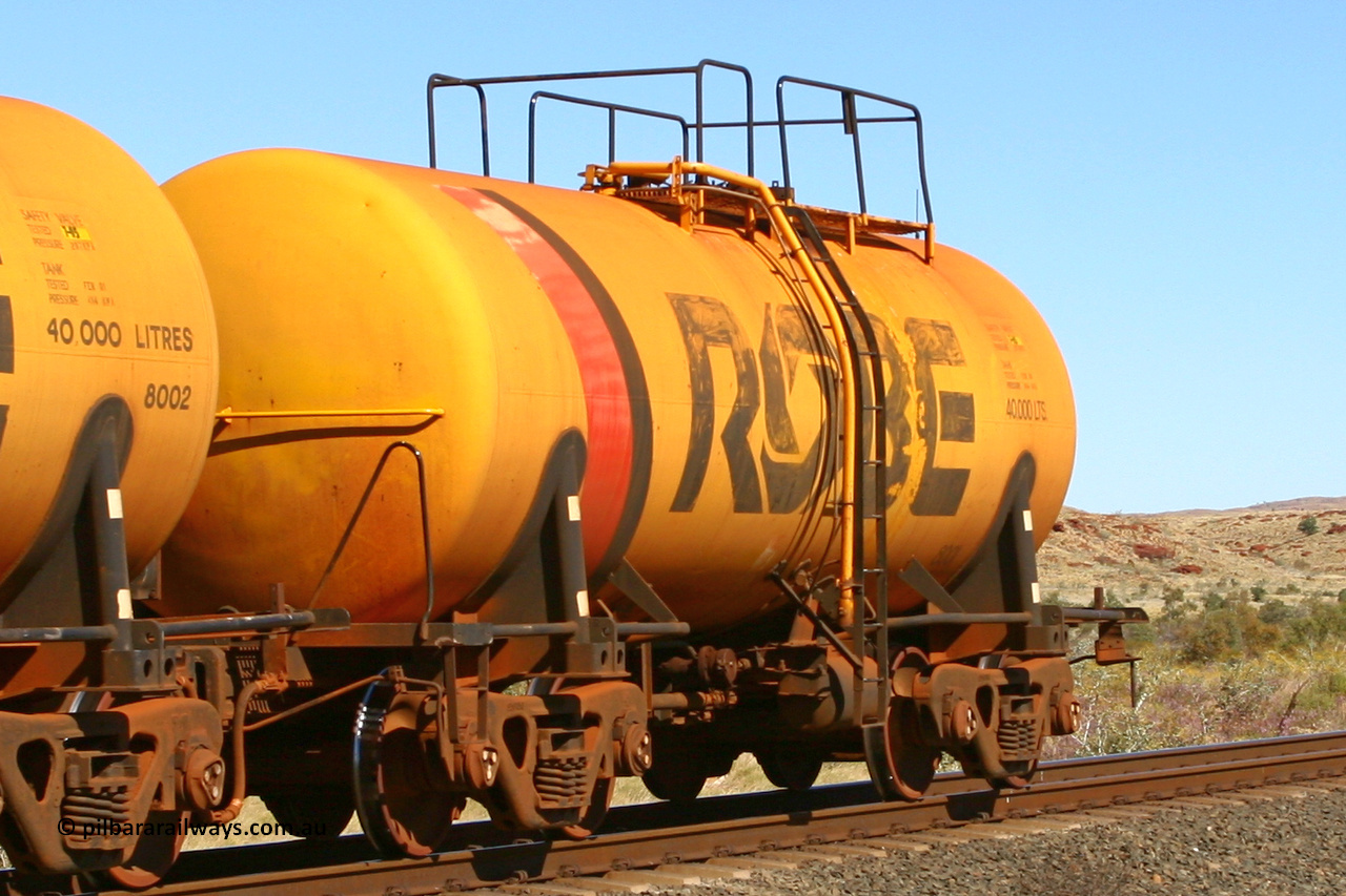 8001 060716 7201
Western Creek, Robe River diesel fuel tank waggon 8001 running empty on a loaded ore train, built by Comeng NSW in September 1972 with a 45,000 litre capacity. 1401 hours, July 16, 2006.
Keywords: 8001;Comeng-NSW;Robe-tank-waggon;