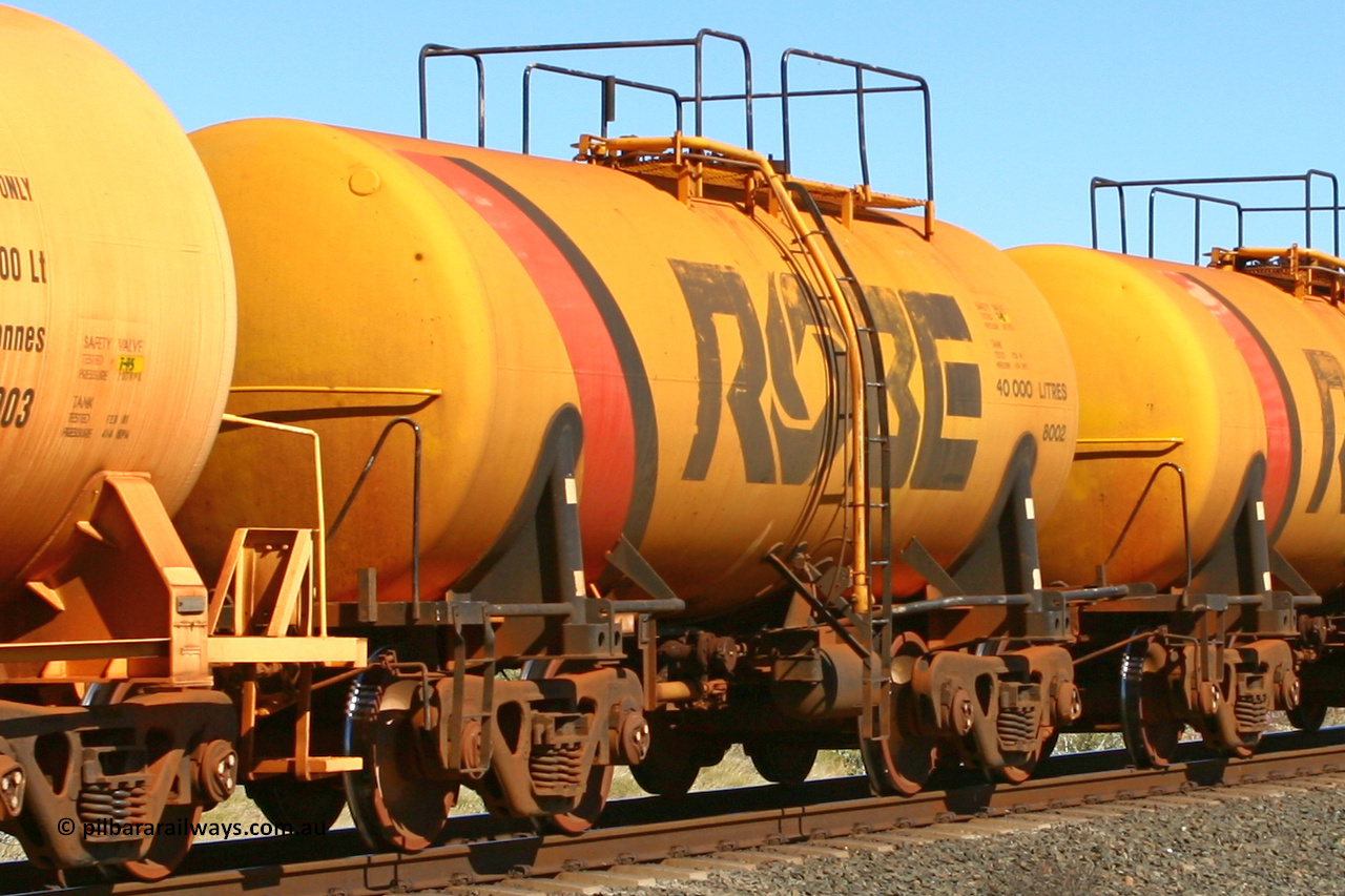 8002 060716 7200
Western Creek, Robe River diesel fuel tank waggon 8002 running empty on a loaded ore train, built by Comeng NSW in September 1972 with a 45,000 litre capacity. 1401 hours, July 16, 2006.
Keywords: 8002;Comeng-NSW;Robe-tank-waggon;