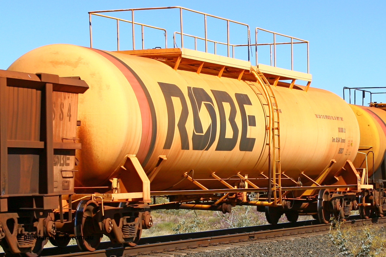 8003 060716 7199
Western Creek, Robe River diesel fuel tank waggon 8003 running empty on a loaded ore train, built by Comeng NSW in March 1979 with a 100,000 litre capacity. 1401 hours, July 16, 2006.
Keywords: 8003;Comeng-NSW;Robe-tank-waggon;
