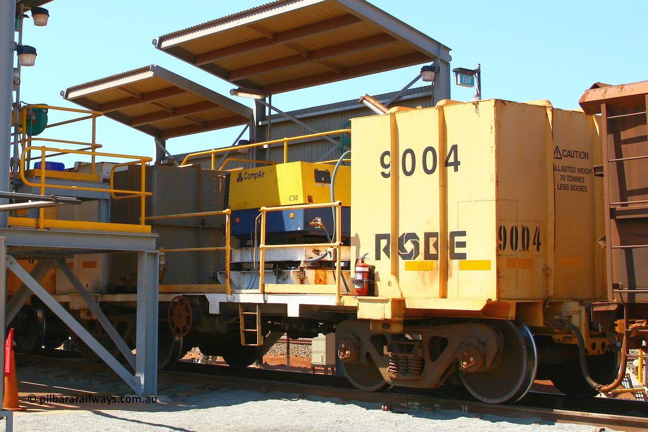 9004 070909 0672
Robe River compressor waggon 9004, a modified Nippon Sharyo Nihon built waggon with a Compair compressor, grey fuel tank, the air receiver is obscured by the yellow ballast block. This style of compressor setup differs greatly from the original compressor waggons built by Nippon Sharyo Nihon. Cape Lambert fuel bay September 9, 2009.
Keywords: 9004;robe-compressor-waggon;