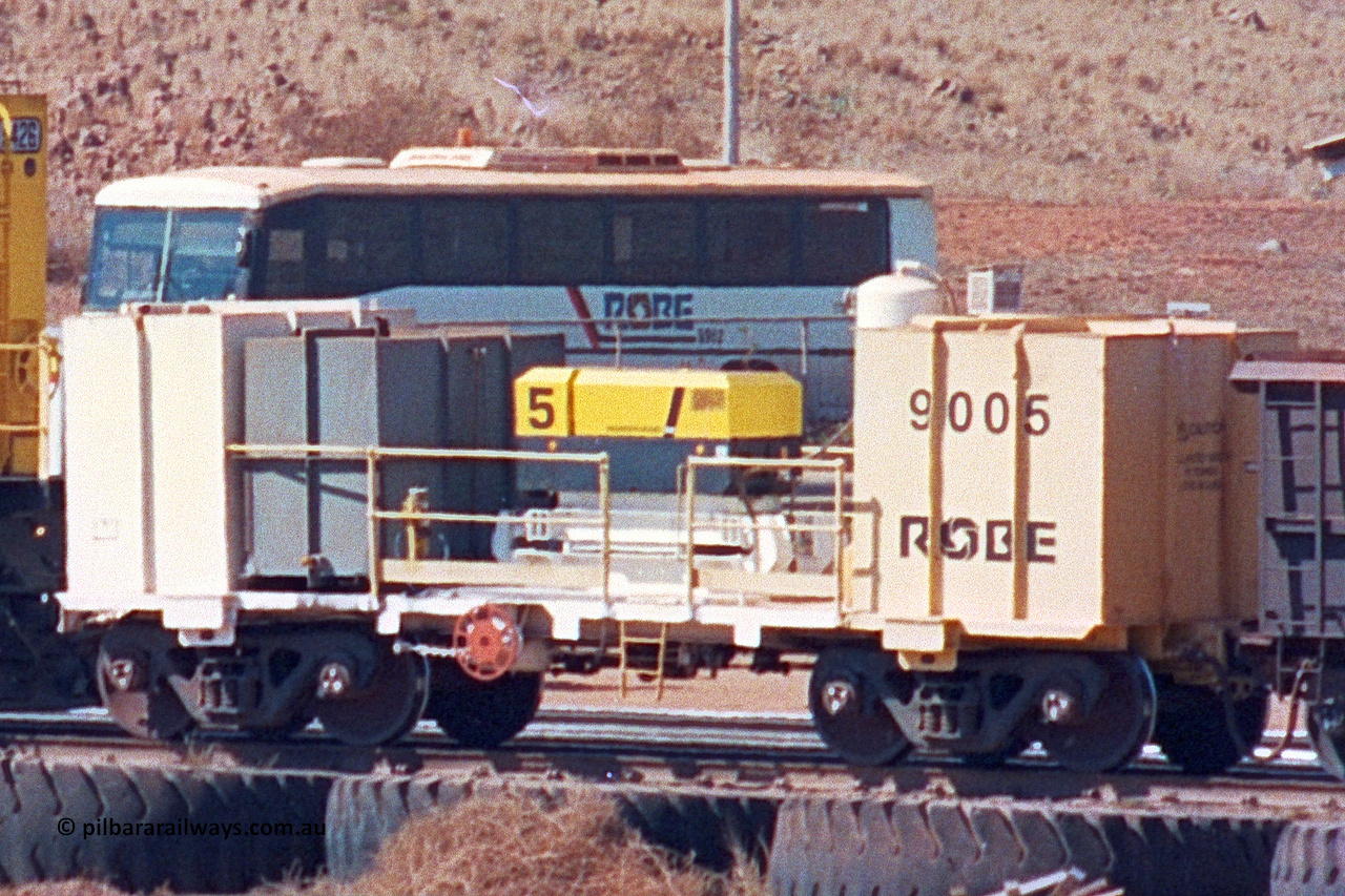 9005 020522 247 03
Robe River compressor waggon 9005, a modified Nippon Sharyo Nihon built waggon with air compressor, grey fuel tank and white air receiver. This style of compressor setup differs greatly from the original compressor waggons built by Nippon Sharyo Nihon. Cape Lambert yard May 22, 2002.
Keywords: 9005;robe-compressor-waggon;