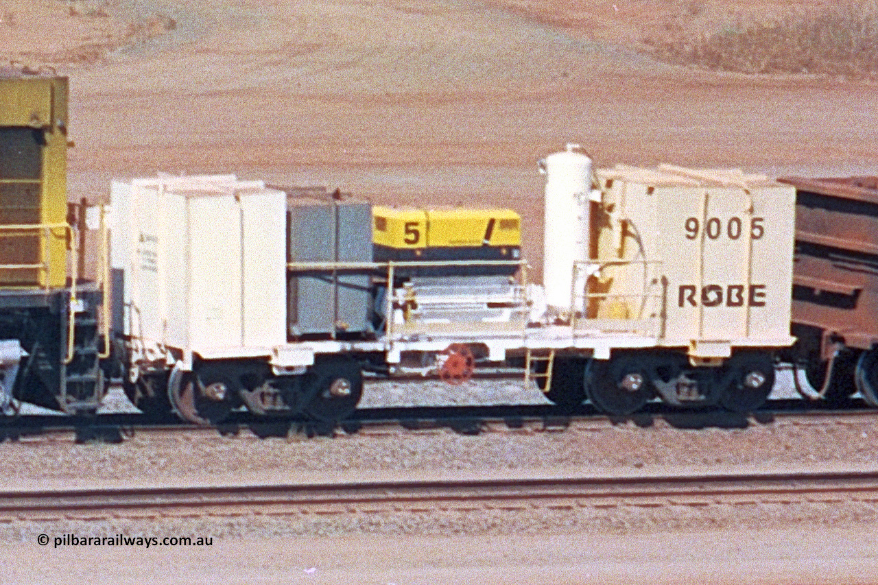 9005 020522 247 04
Robe River compressor waggon 9005, a modified Nippon Sharyo Nihon built waggon with air compressor, grey fuel tank and white air receiver. This style of compressor setup differs greatly from the original compressor waggons built by Nippon Sharyo Nihon. Cape Lambert yard May 22, 2002.
Keywords: 9005;robe-compressor-waggon;
