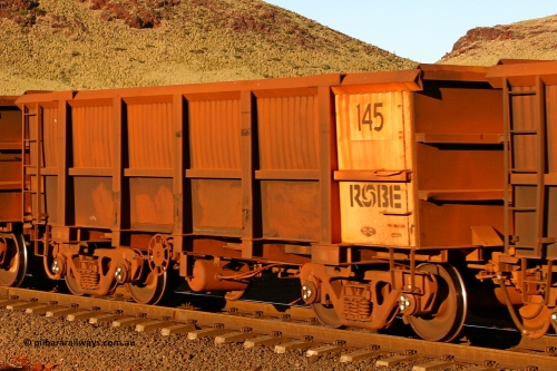 0145 060722 7597
Robe River ore waggon 145, built by Nippon Sharyo Nihon, rotary coupler end handbrake side empty view, at the 11.7 km, Cape Lambert. July 22, 2006.
Keywords: 145;Nippon-Sharyo-Nihon;Robe-ore-waggon;