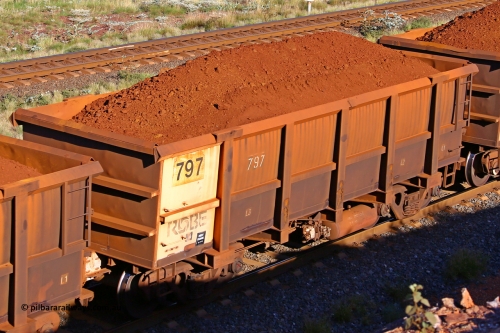 0797 210322 9766
Robe River ore waggon 797, built by Centurion Industries  WA, rotary coupler end non-handbrake side loaded view at the 17 km on the Cape Lambert line, March 22, 2021.
Keywords: 797;Centurion-Industries-WA;Robe-ore-waggon;