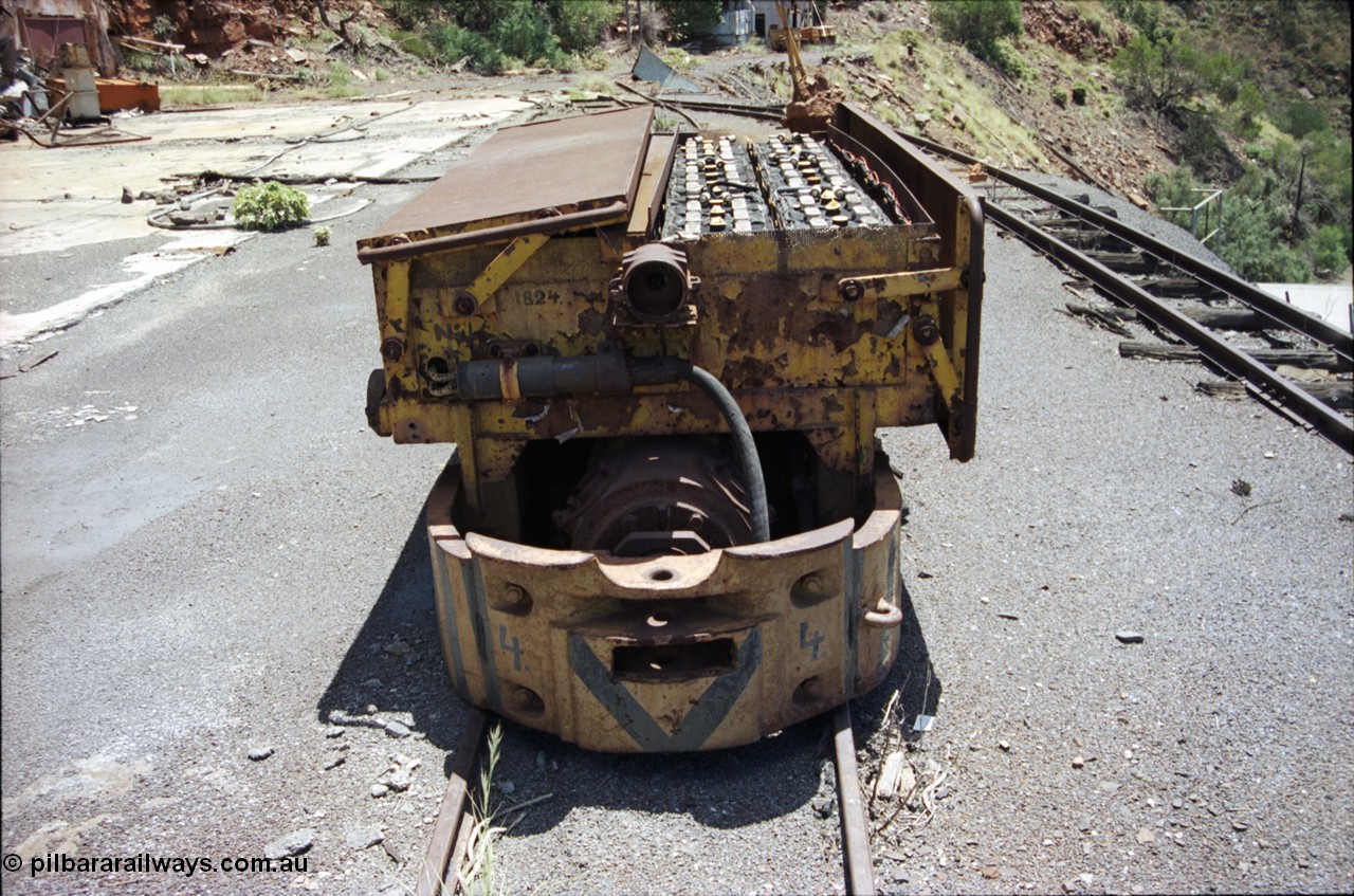 197-14
Wittenoom, Colonial Mine, asbestos mining remains, Mancha battery locomotive #4 looking north west, demolished workshops and office on the left, mine adit doors visible, compressor building in the distance.
Keywords: Mancha;