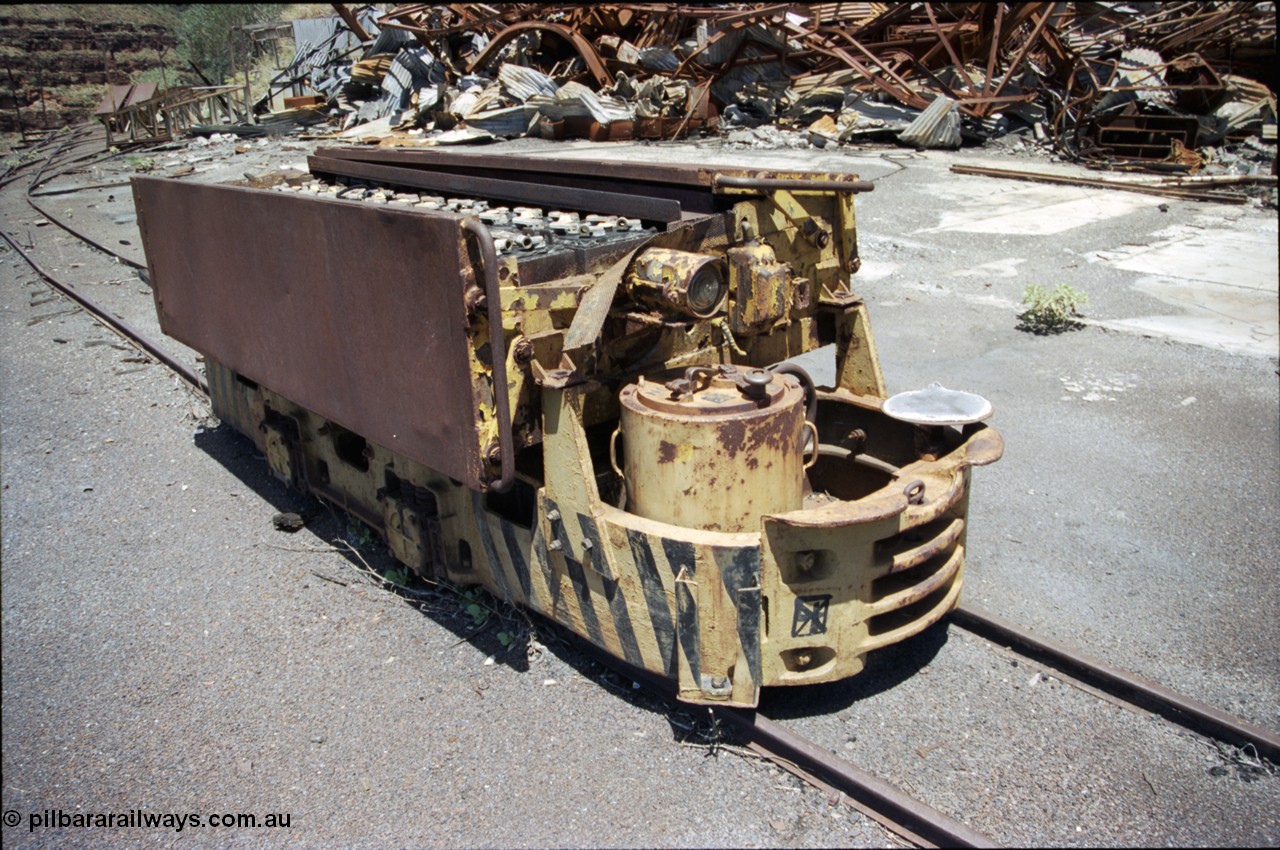 197-16
Wittenoom, Colonial Mine, asbestos mining remains, Mancha battery locomotive #4 looking south east, demolished workshops and office behind with the battery charging shed remains in the distance. Drivers seat, brake wheel and controller visible.
Keywords: Mancha;