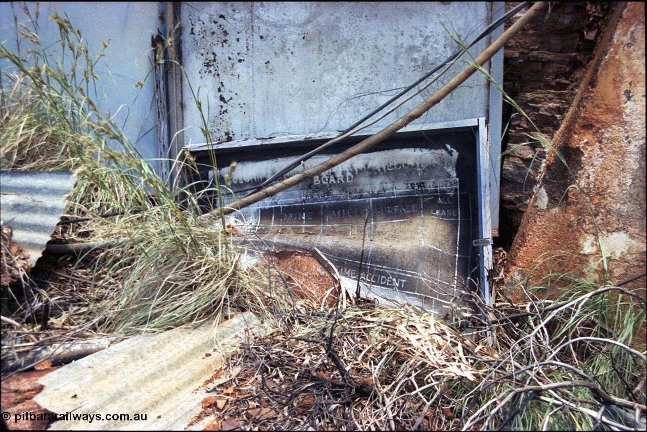 197-21
Wittenoom, Colonial Mine, asbestos mining remains, view of the accident statistic board located at the main mine adit.
