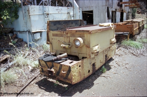 197-28
Wittenoom, Colonial Mine, reverse view of 197-27, battery module No.1 with number 10165, shows a slotted drop type hinge arrangement, headlight, coupling pocket and Joy plug for motor, mounted on an English Electric hauler, behind is a Gemco and two Mancha units, the building is the water treatment and compressor sheds.
Keywords: Dick-Kerr;DB1;English-Electric;