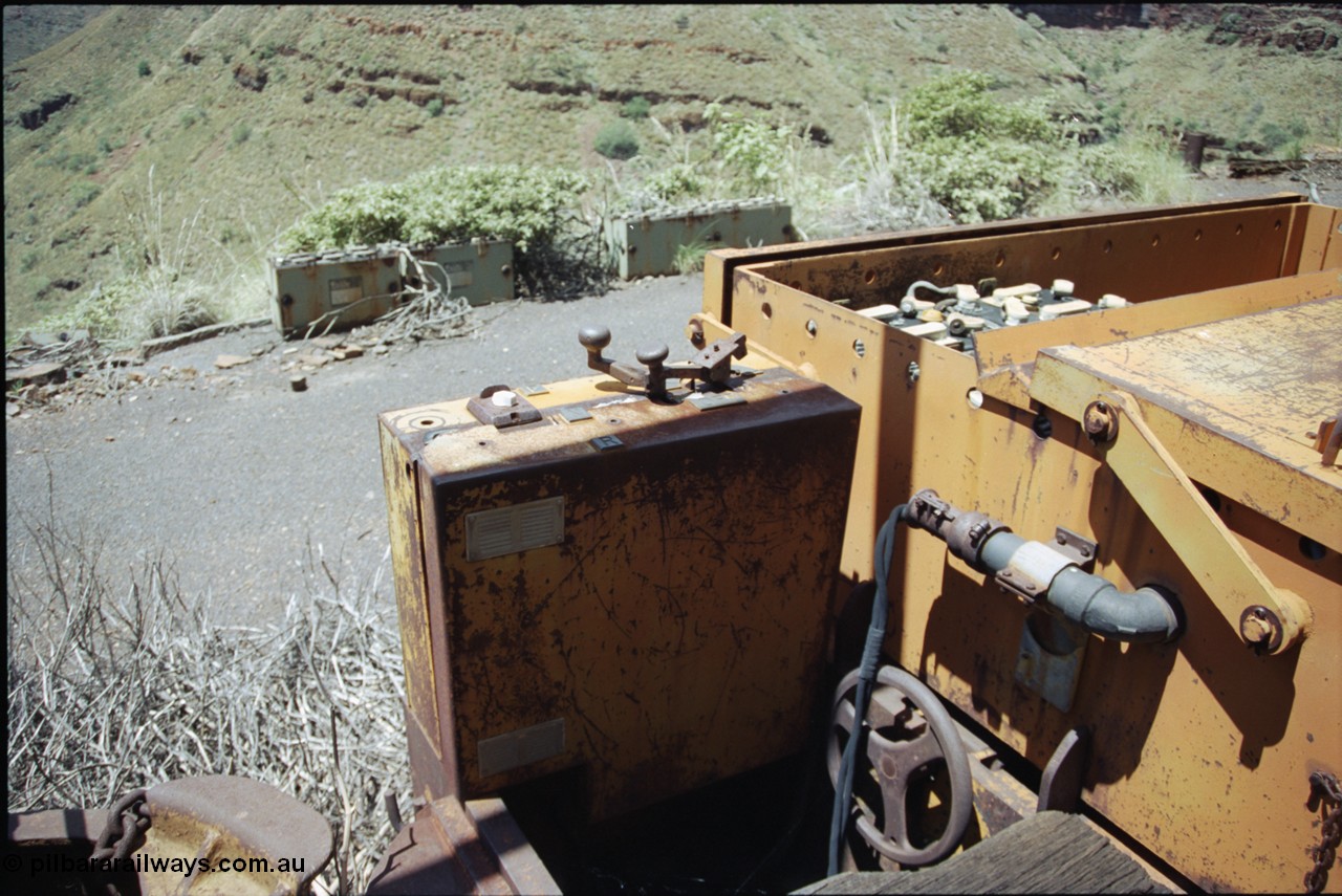 198-03
Wittenoom, Colonial Mine, asbestos mining remains, view of driving position, throttle and battery box of battery locomotive GEMCO Hauler serial No. 12304-05/10/65, motor H.P. 2/11, volts 80, drawbar pull (lbs.) 1250 built by George Moss Pty Ltd Leederville, WA. The wheel is the handbrake.
Keywords: Gemco;George-Moss;12304-05/10/65;