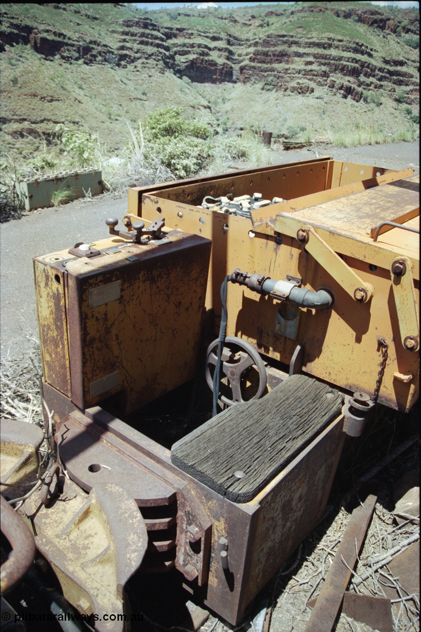 198-04
Wittenoom, Colonial Mine, asbestos mining remains, view of driving position, throttle and battery box of battery locomotive GEMCO Hauler serial 12304-05/10/65, motor H.P. 2/11, volts 80, drawbar pull (lbs.) 1250 built by George Moss Pty Ltd Leederville, WA. The wheel is the handbrake.
Keywords: Gemco;George-Moss;12304-05/10/65;