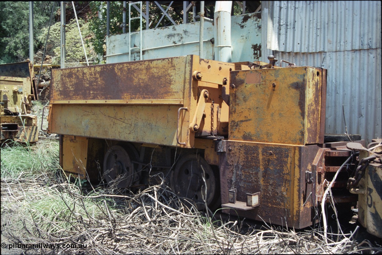 198-05
Wittenoom, Colonial Mine, asbestos mining remains, front view of throttle control box, battery box and wheel and brake arrangement of battery locomotive GEMCO Hauler serial 12304-05/10/65, motor H.P. 2/11, volts 80, drawbar pull (lbs.) 1250 built by George Moss Pty Ltd Leederville, WA.
Keywords: Gemco;George-Moss;12304-05/10/65;