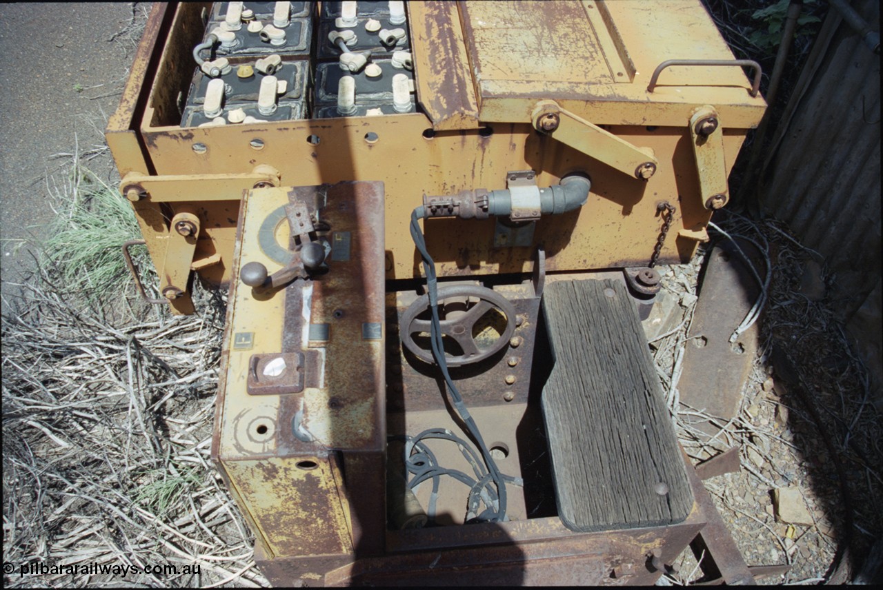 198-09
Wittenoom, Colonial Mine, asbestos mining remains, view of driving position, reverser and throttle, brake wheel, timber seat, battery plug and battery box of battery locomotive GEMCO Hauler serial 12304-05/10/65, motor H.P. 2/11, volts 80, drawbar pull (lbs.) 1250 built by George Moss Pty Ltd Leederville, WA.
Keywords: Gemco;George-Moss;12304-05/10/65;