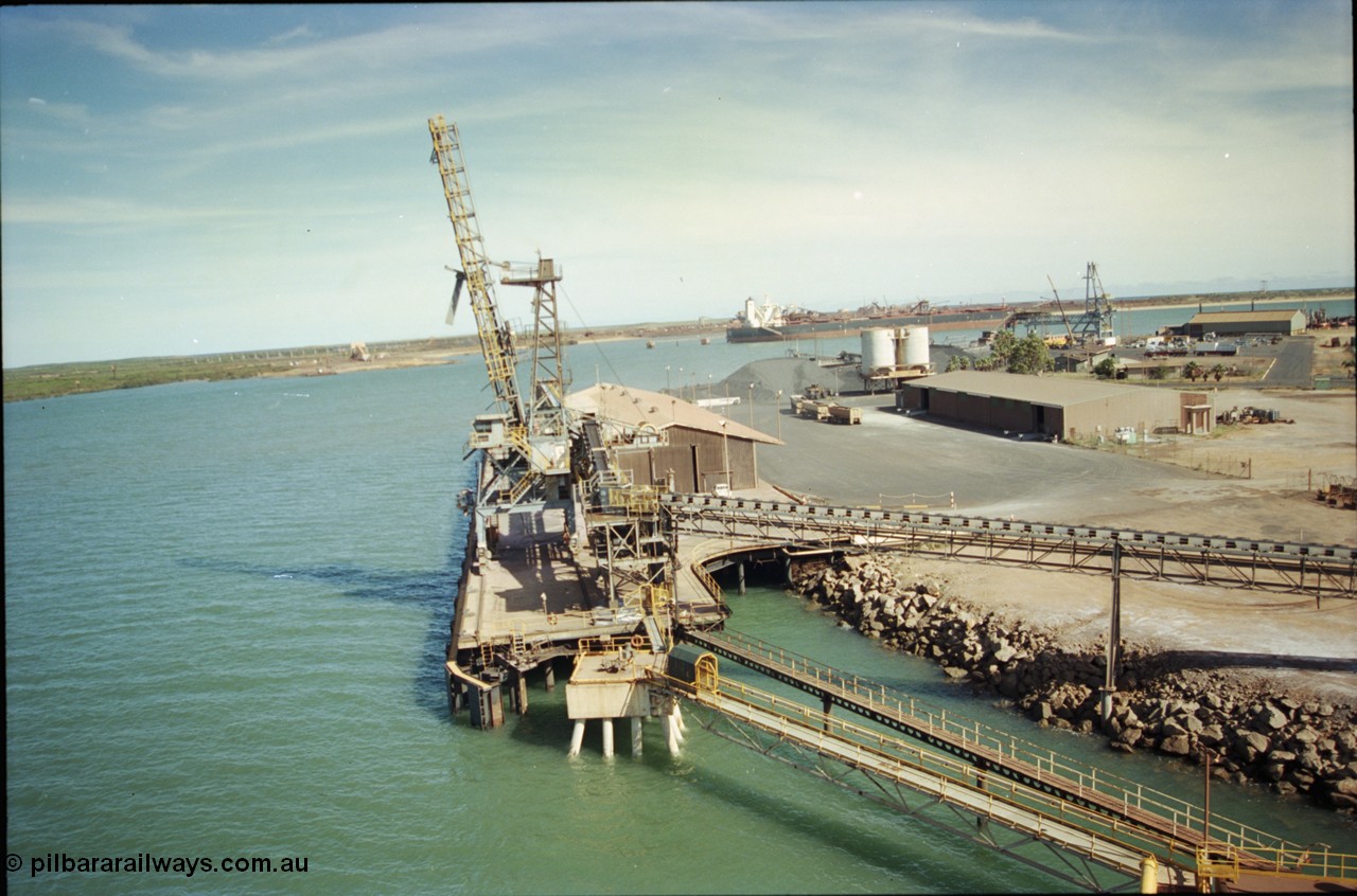 198-15
Port Hedland Port, view of the Cargill Salt berth and loader, or PHPA Berth No. 3, in this 2001 view, the then new bulker loader is under construction and manganese is stockpiled on the ground. The BHP Finucane Island berth is visible along with the overland conveyor for the HBI plant.
