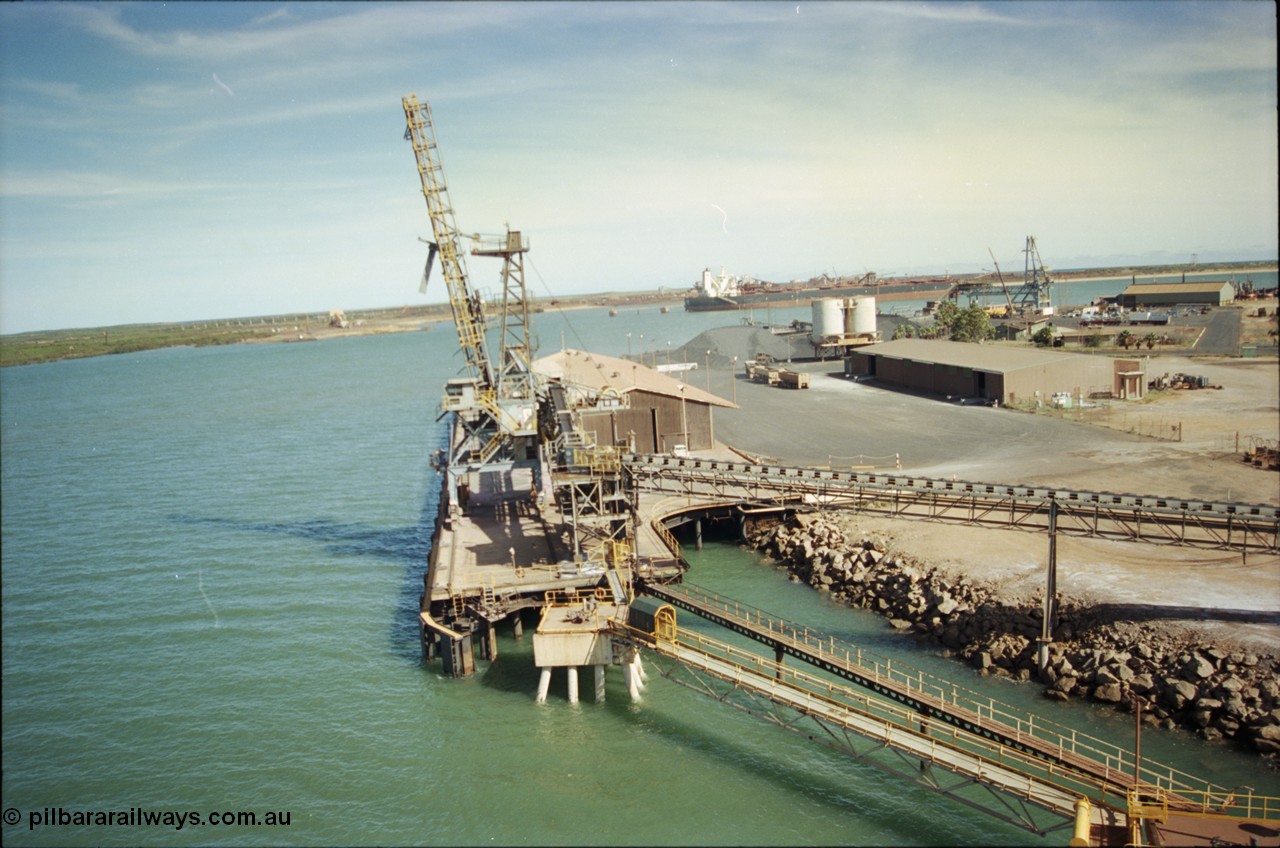 198-16
Port Hedland Port, view of the Cargill Salt berth and loader, or PHPA Berth No. 3, in this 2001 view, the then new bulker loader is under construction and manganese is stockpiled on the ground. The BHP Finucane Island berth is visible along with the overland conveyor for the HBI plant.
