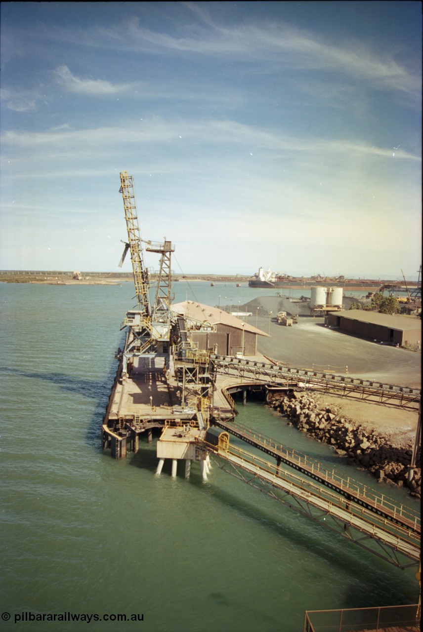 198-18
Port Hedland Port, view of the Cargill Salt berth and loader, or PHPA Berth No. 3, in this 2001 view, the then new bulker loader is under construction and manganese is stockpiled on the ground. The BHP Finucane Island berth is visible along with the overland conveyor for the HBI plant.
