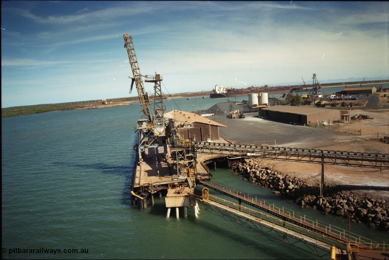 198-19
Port Hedland Port, view of the Cargill Salt berth and loader, or PHPA Berth No. 3, in this 2001 view, the then new bulker loader is under construction and manganese is stockpiled on the ground. The BHP Finucane Island berth is visible along with the overland conveyor for the HBI plant.
