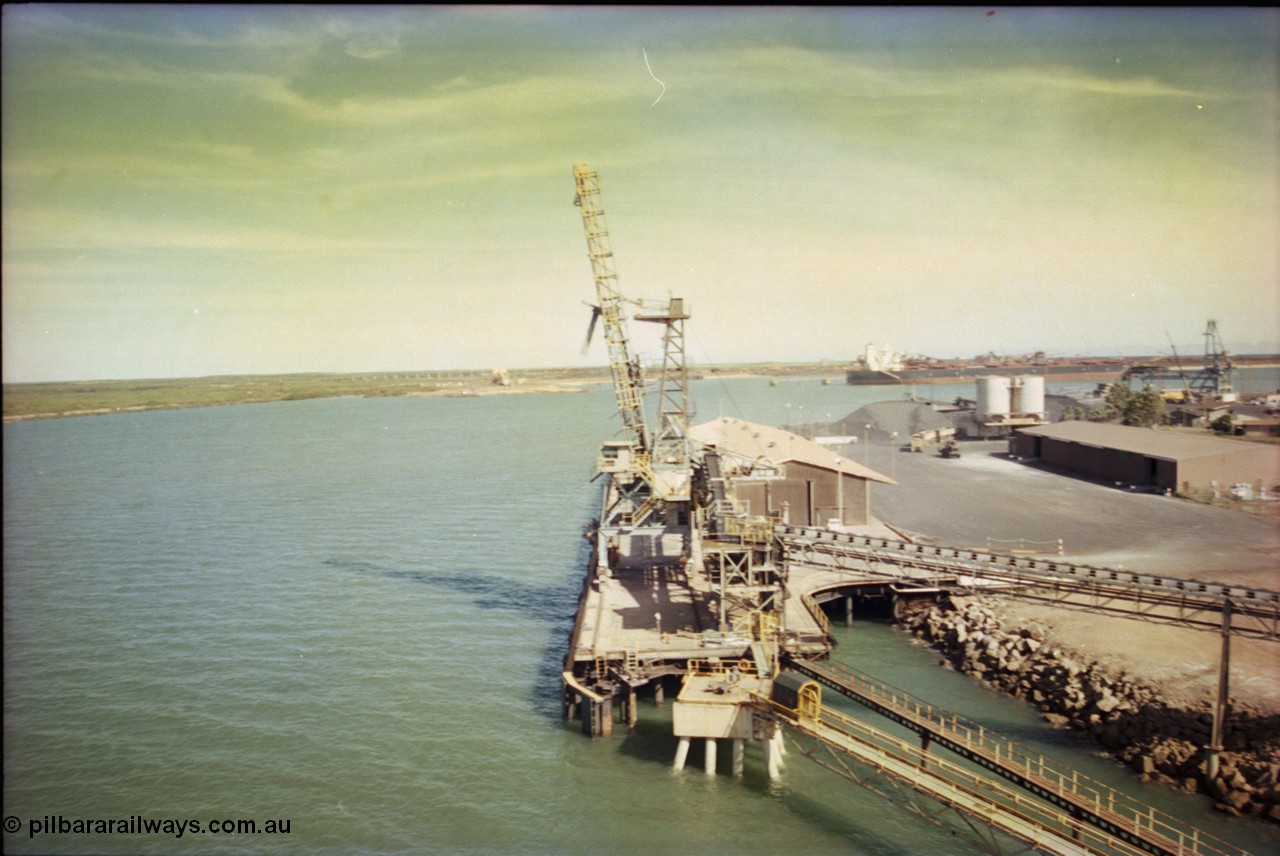 198-20
Port Hedland Port, view of the Cargill Salt berth and loader, or PHPA Berth No. 3, in this 2001 view, the then new bulker loader is under construction and manganese is stockpiled on the ground. The BHP Finucane Island berth is visible along with the overland conveyor for the HBI plant.
