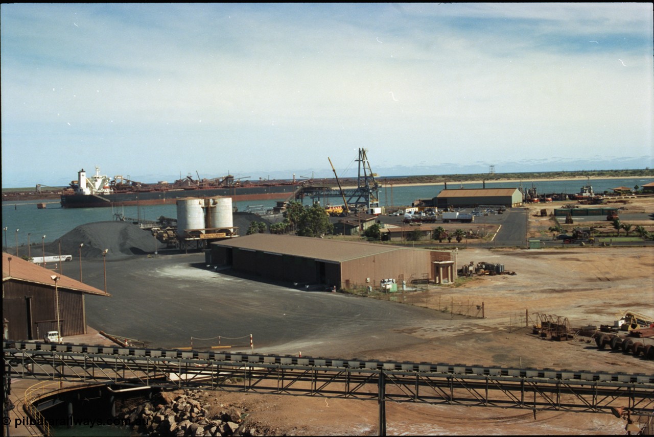 198-23
Port Hedland Port, view of the hard stand and overview of the PHPA, manganese is stockpiled around the former Cockburn Cement silos, new bulk loader under construction, tug pen visible along with single berth at BHP Finucane Island.
