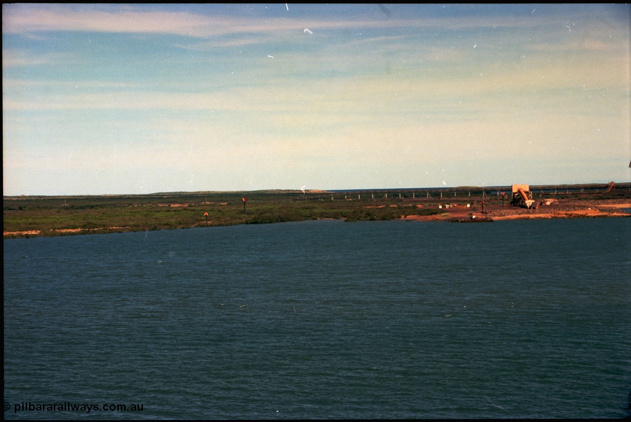 198-30
Port Hedland Port, view of the BHP HBI plant overland conveyor and under-harbour tunnel portal, also Utah Point Boat Ramp. This area is now changed with Pilbara Ports Authority No.4 Berth, and three additional berths for BHP Billiton. Images taken 2001.
