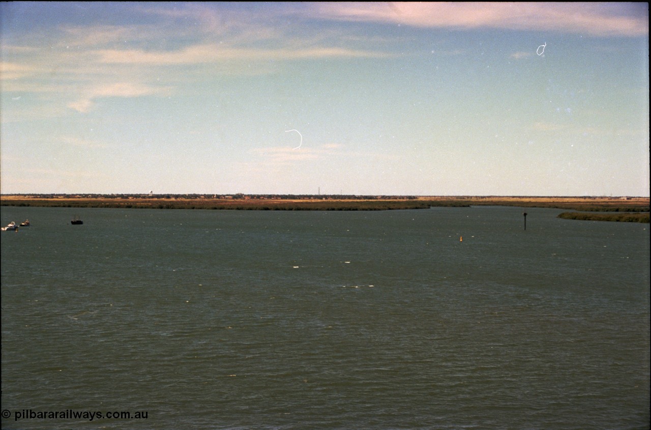 198-32
Port Hedland Port, view of ship turning basin with the South Hedland water tank in the distance, FMG now have a three berths in this location on the right. Early 2001.
