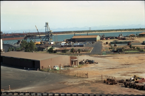 198-24
Port Hedland Port, overview of the hard stand area, salt conveyor at very bottom of image. New bulk loader under construction, tug pen and BHP Transport admin building visible at top right. Circa 2001.
