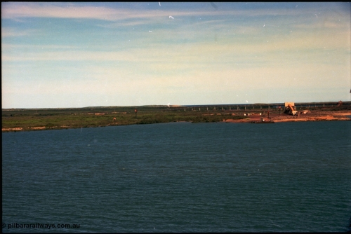 198-30
Port Hedland Port, view of the BHP HBI plant overland conveyor and under-harbour tunnel portal, also Utah Point Boat Ramp. This area is now changed with Pilbara Ports Authority No.4 Berth, and three additional berths for BHP Billiton. Images taken 2001.
