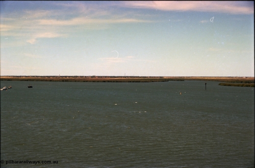 198-32
Port Hedland Port, view of ship turning basin with the South Hedland water tank in the distance, FMG now have a three berths in this location on the right. Early 2001.
