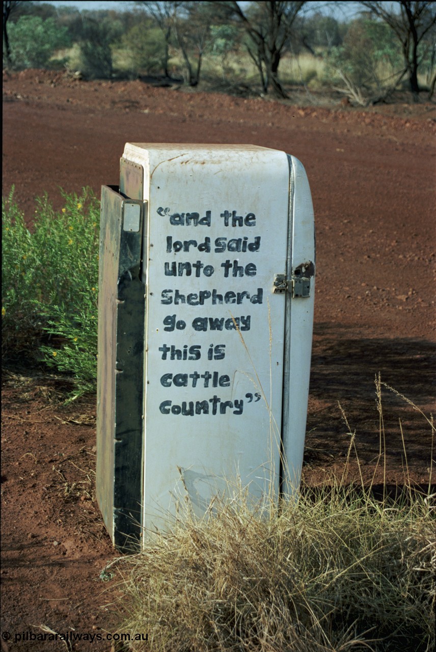 205-04
Hooley Station front gate, old refrigerator used for mailbox, 'and the lord said unto the Shepard go away this is cattle country'.
